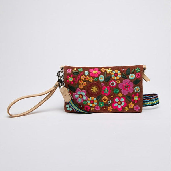 Floral embroidered clutch with a strap on a white background