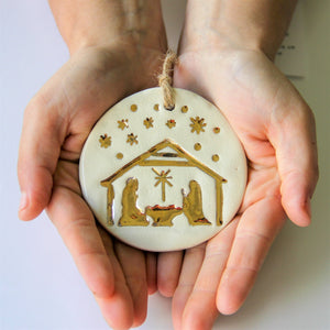 Gold Nativity scene on pottery ornament