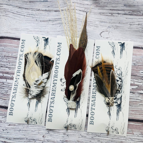Feathered hair clips on a wooden surface