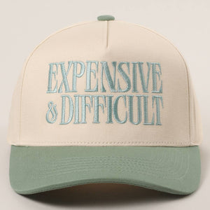 Beige and green cap with 'EXPENSIVE & DIFFICULT' text on a light gray background
