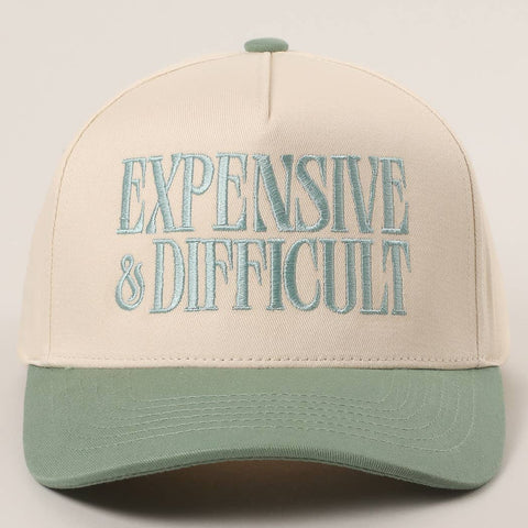 Beige and green cap with 'EXPENSIVE & DIFFICULT' text on a light gray background