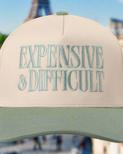 Beige cap with 'EXPENSIVE & DIFFICULT' text in front of the Eiffel Tower.