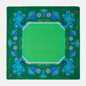 Green mahjong mat with blue floral patterns on a green background