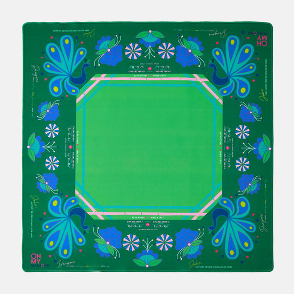 Green mahjong mat with blue floral patterns on a green background