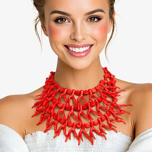 Woman wearing a red necklace against a white background