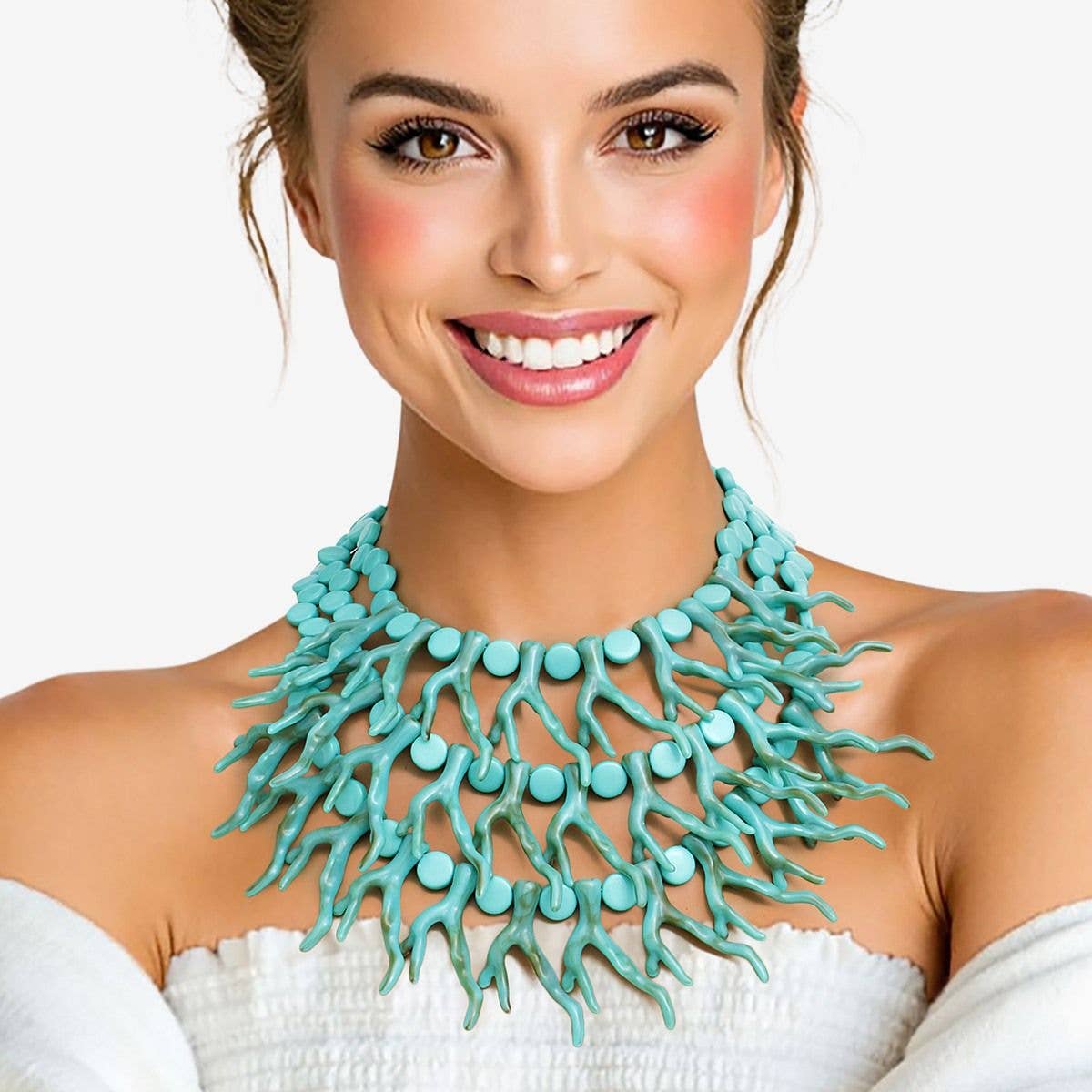 Woman wearing a turquoise necklace against a white background