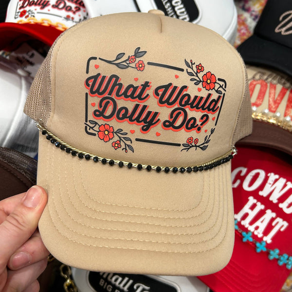 Beige cap with 'What Would Dolly Do?' text held in front of other caps.