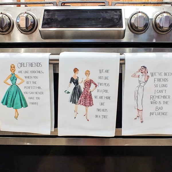 Front of oven with 3 Kitchen Towels with 1950's models pictured and Sassy Sayings such as Girlfriends and Cocktails, Two Peas in a Pod, and We've been friends so long.